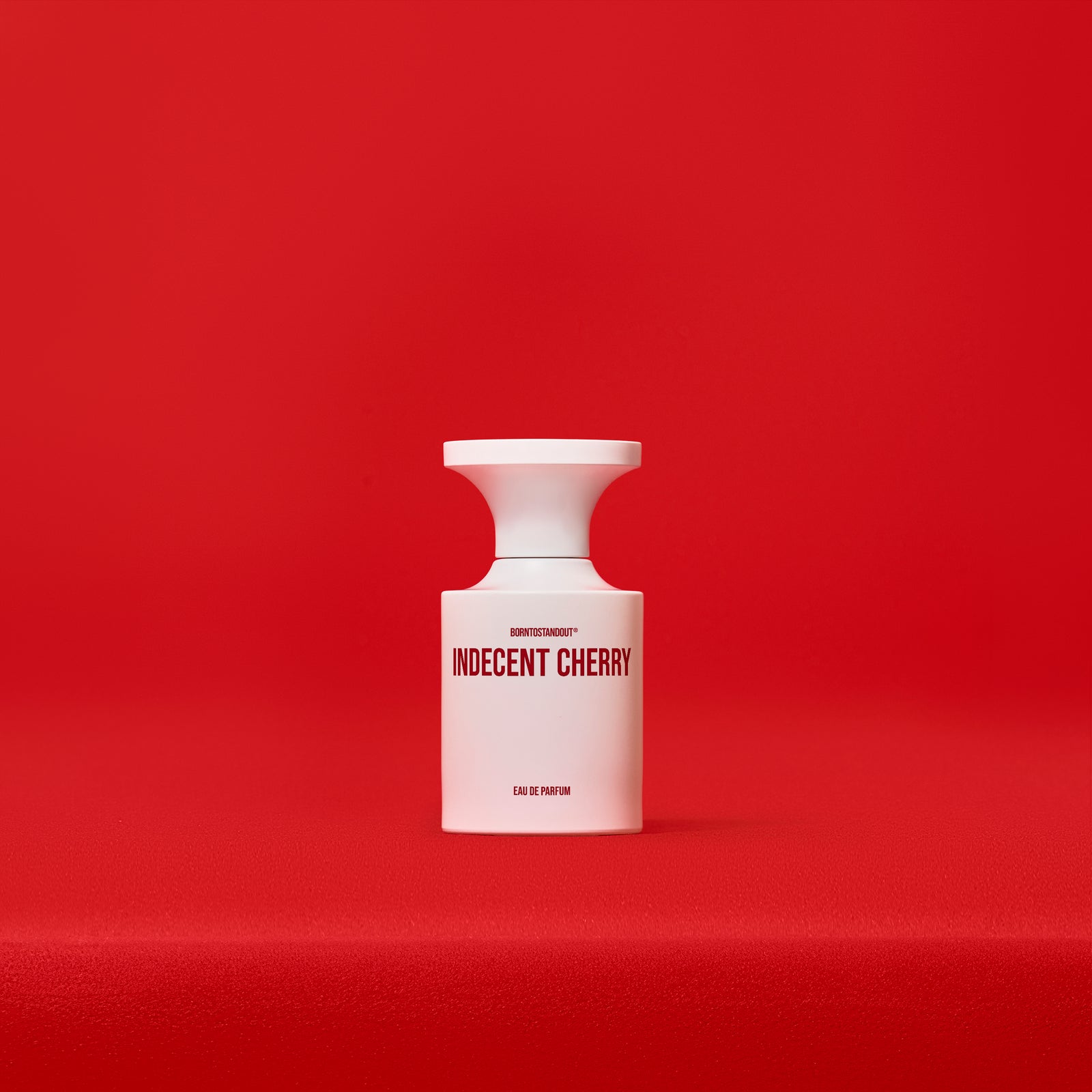 BORNTOSTANDOUT Indecent Cherry Eau de Parfum 50 ml, baltas matinis buteliukas raudoname fone